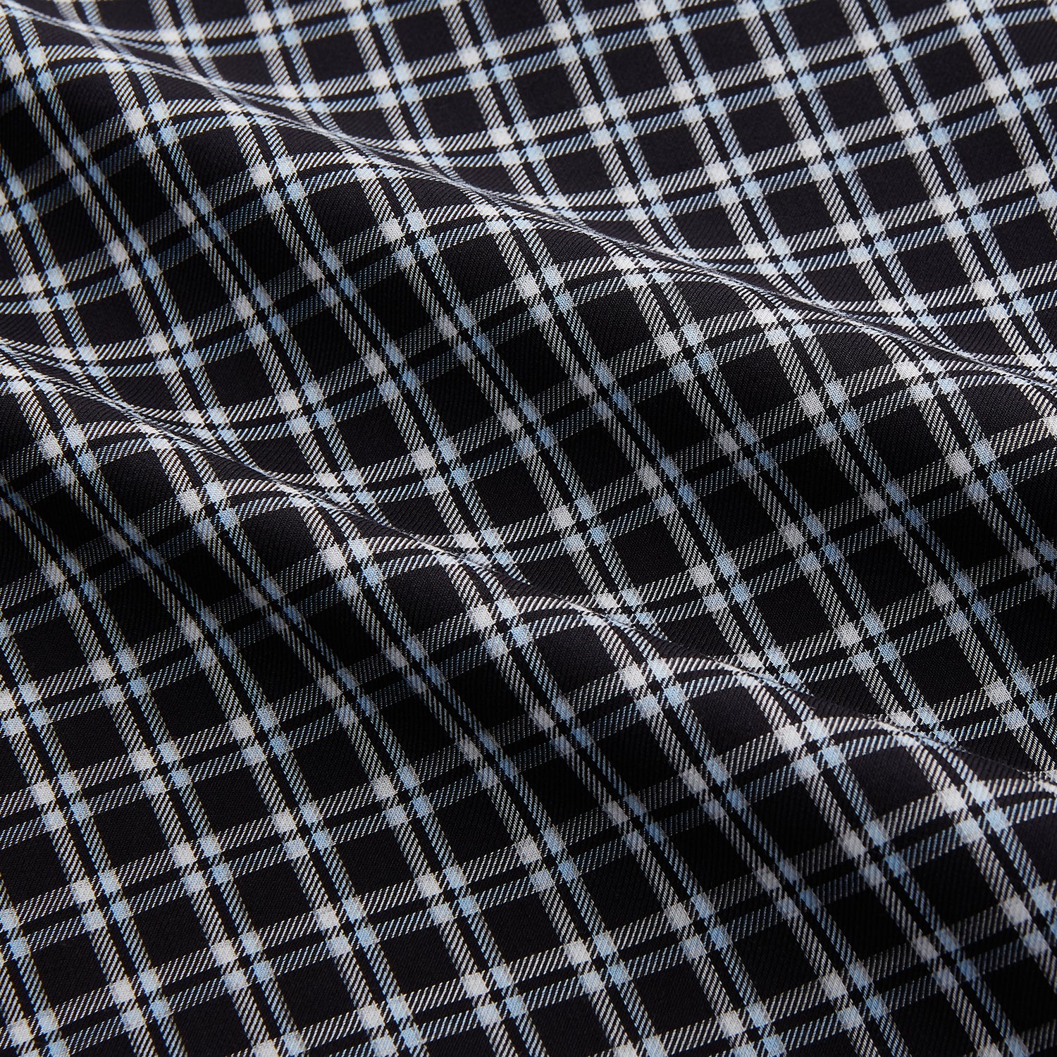 View 4 of product The Turnbull & Asser Black Multi Check Cotton Blend Weekend Fit Hayne Shirt features a Dorset button-down collar and white buttons, with a black and white plaid pattern, shown laid flat on a white background.