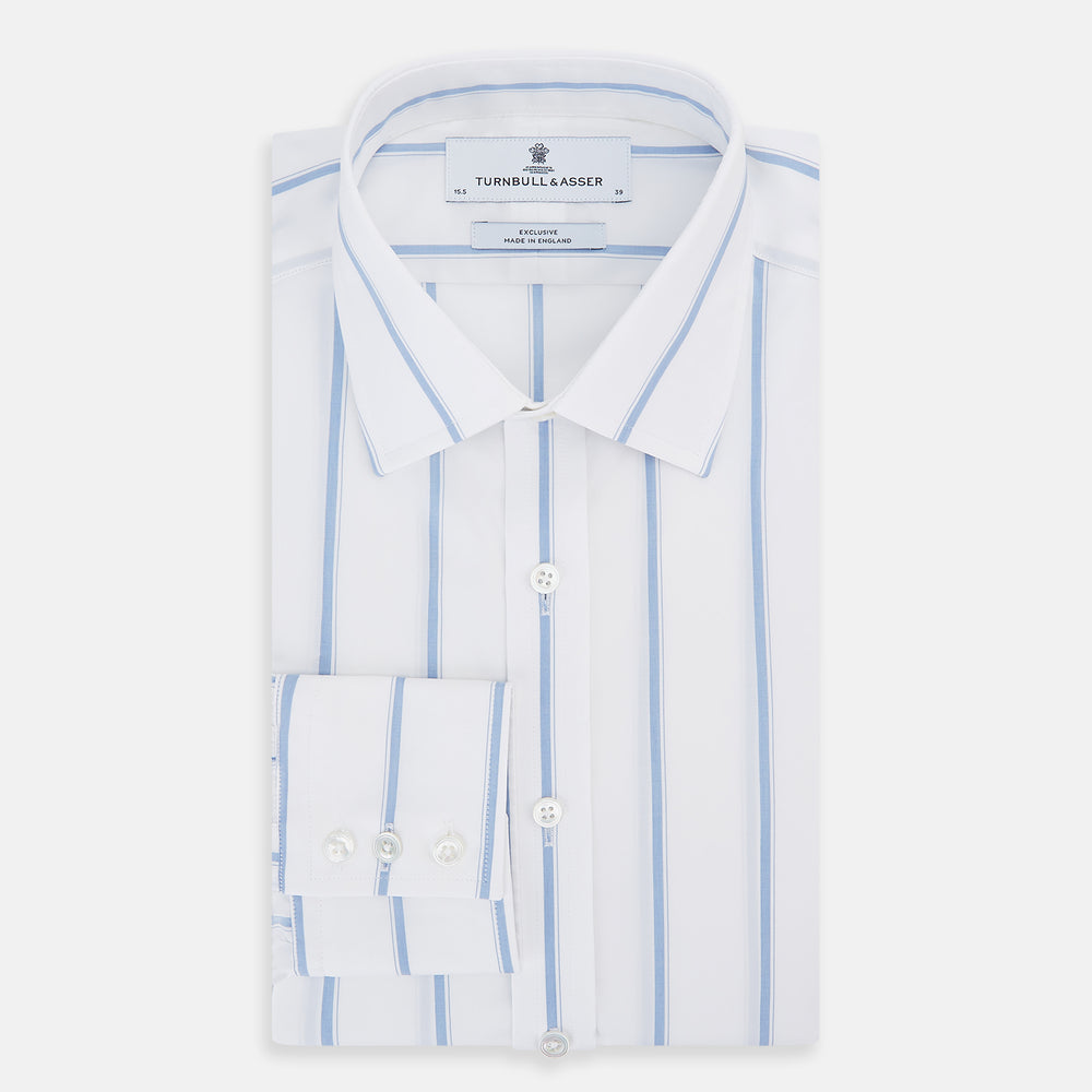 The Colony Blue Track Stripe Mayfair Shirt by Turnbull & Asser is a long-sleeve, button-up Italian cotton shirt with a white base and blue stripes, pointed collar, and buttoned cuffs, shown laid flat on a white background.