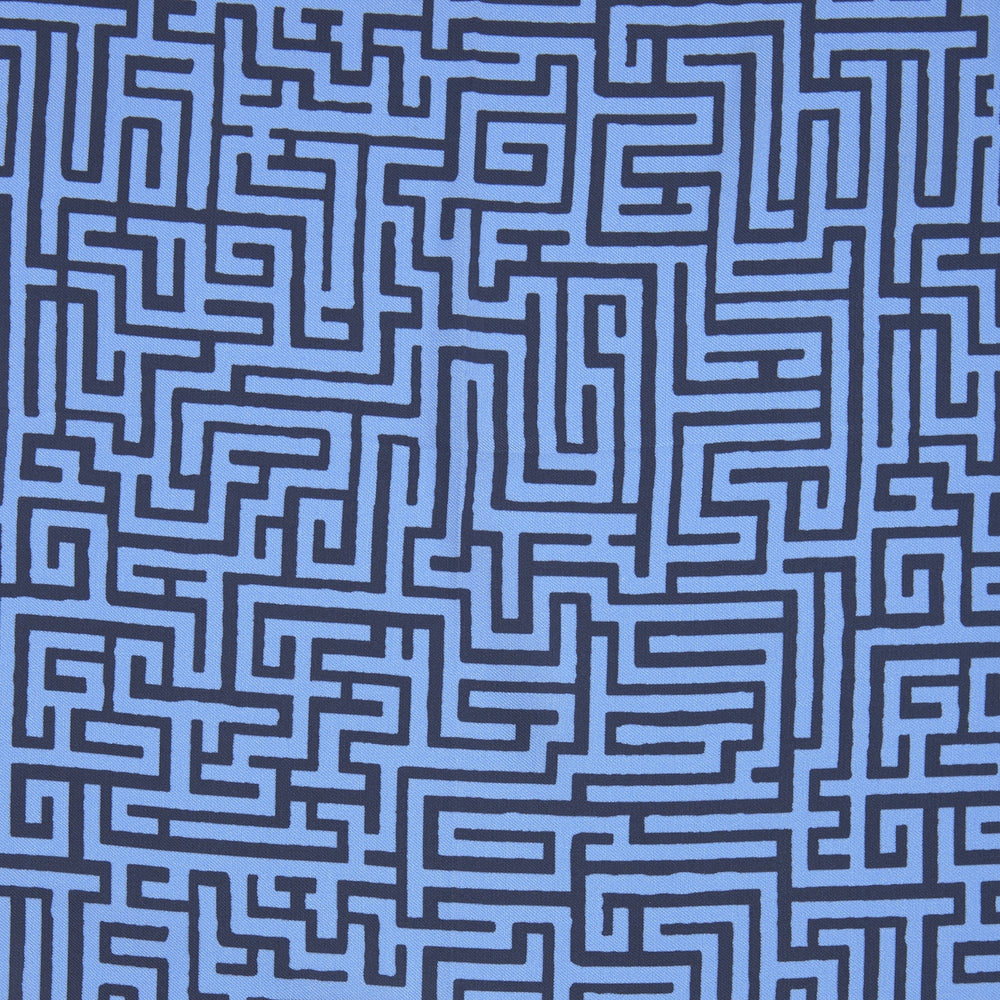 The Blue Maze Silk Pocket Square by Turnbull & Asser features a geometric maze-inspired pattern and central logo, with a folded corner for an artful touch.