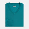 View 4 of product The Turnbull & Asser Turquoise Fine Merino V-Neck Jumper features long sleeves, ribbed cuffs and waistband, shown on a white background—a timeless choice for classic knitwear enthusiasts.
