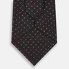 View 3 of product The Turnbull & Asser Turquoise and Forest Green Micro Dot Silk Tie is rolled up, showcasing evenly spaced micro dots on silk, displayed against a plain white background.