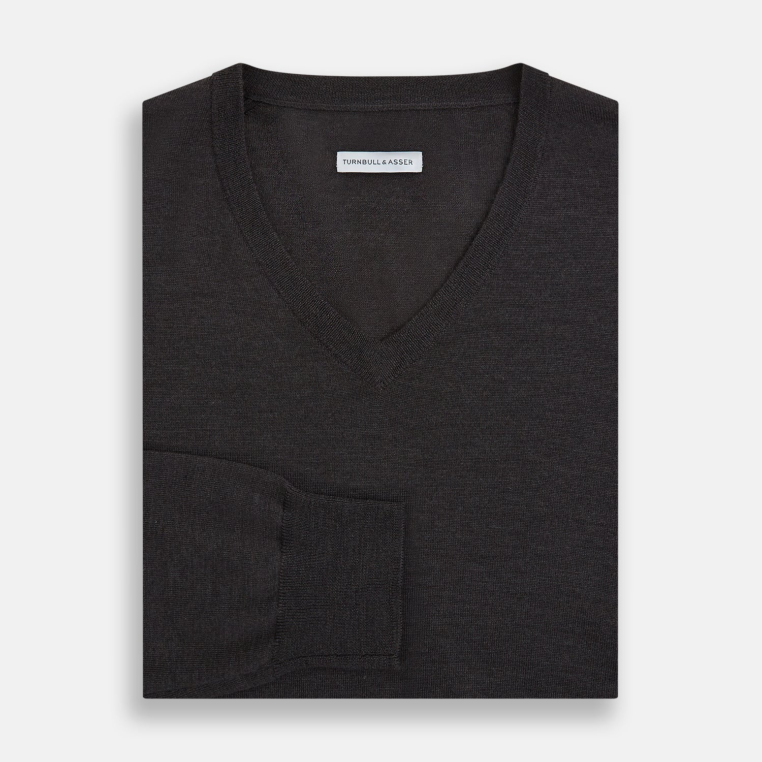 View 4 of product The Turnbull & Asser Charcoal Grey Merino V Neck Jumper is a classic long-sleeve knit with ribbed cuffs and hem, featured in our knitwear collection and shown against a white background.