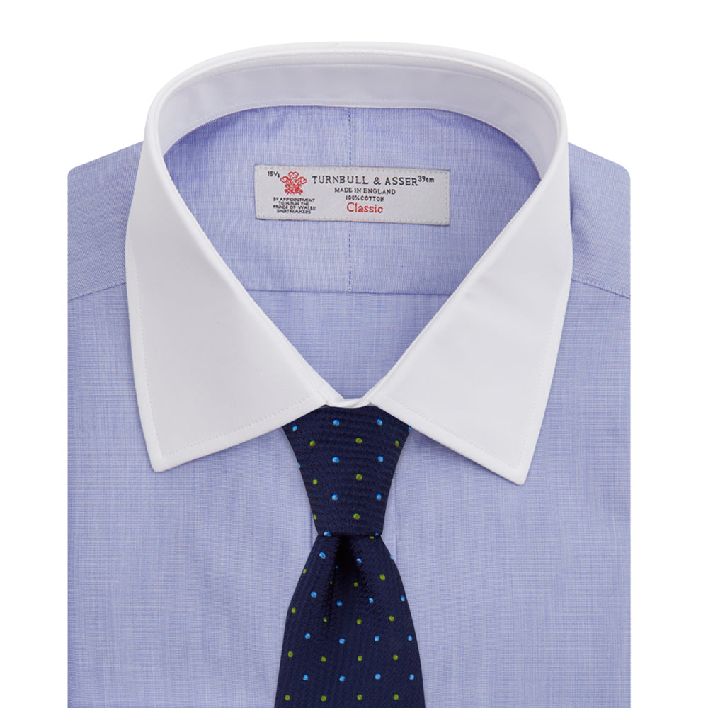 The Wall Street Shirt with White T&A Collar by Turnbull & Asser, as seen on Gordon Gekko, is folded neatly to showcase its light purple color, crisp French cuffs, and iconic contrasting collar against a plain background.