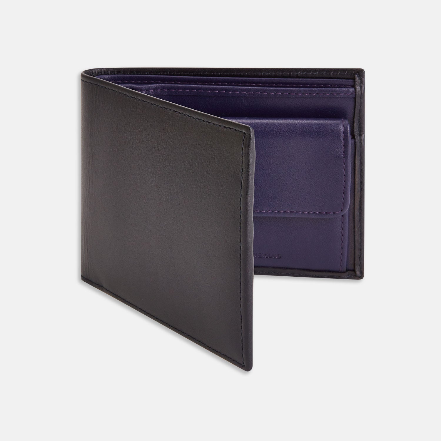 View 1 of product The Turnbull & Asser Bill Coin Wallet is a black leather bifold with a visible purple interior, card slots, and a coin pocket.