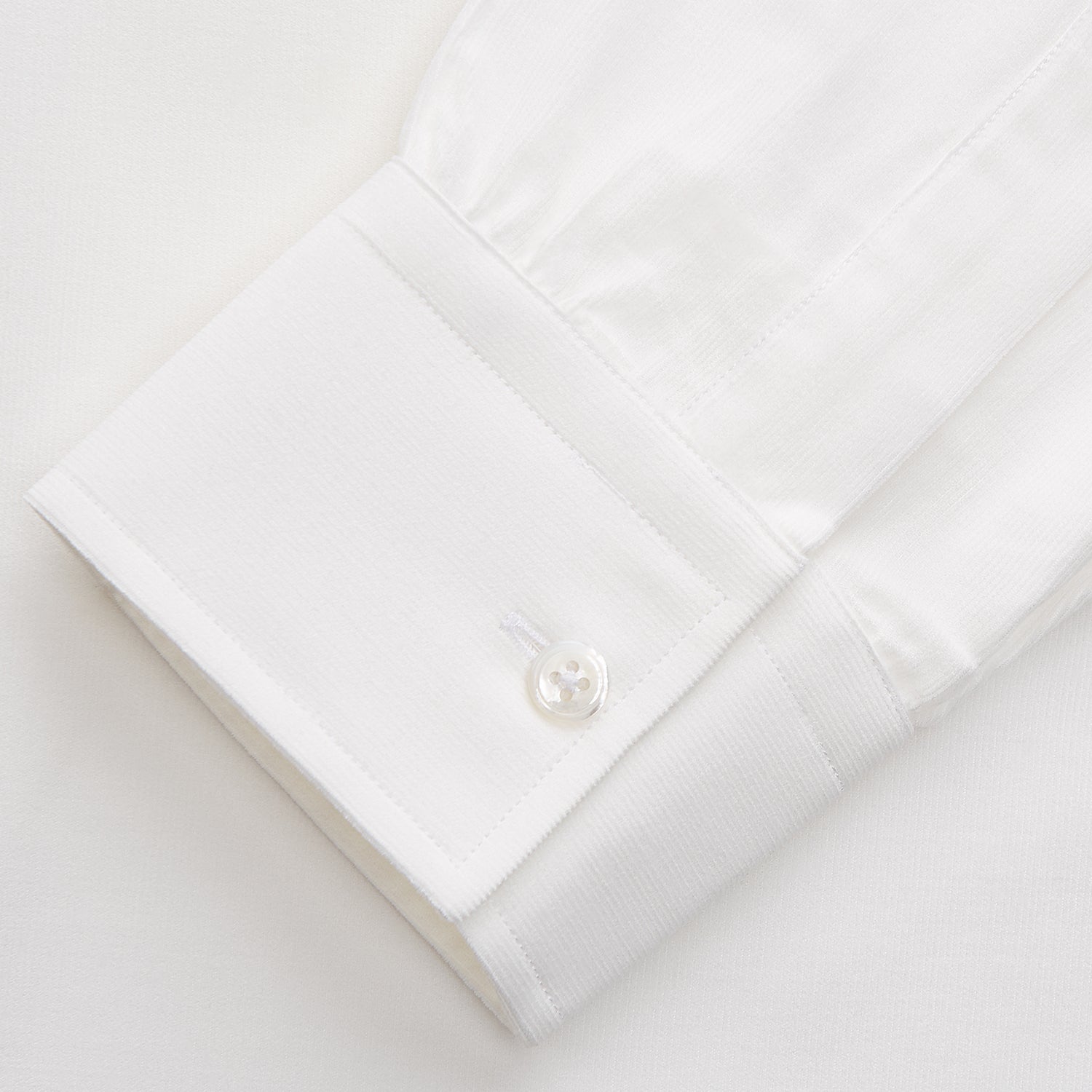 View 2 of product The White Cotton Weekend Fit Langston Shirt by Turnbull & Asser, with a Derby collar, long sleeves, and two button-flap chest pockets, is shown laid flat on a white background.