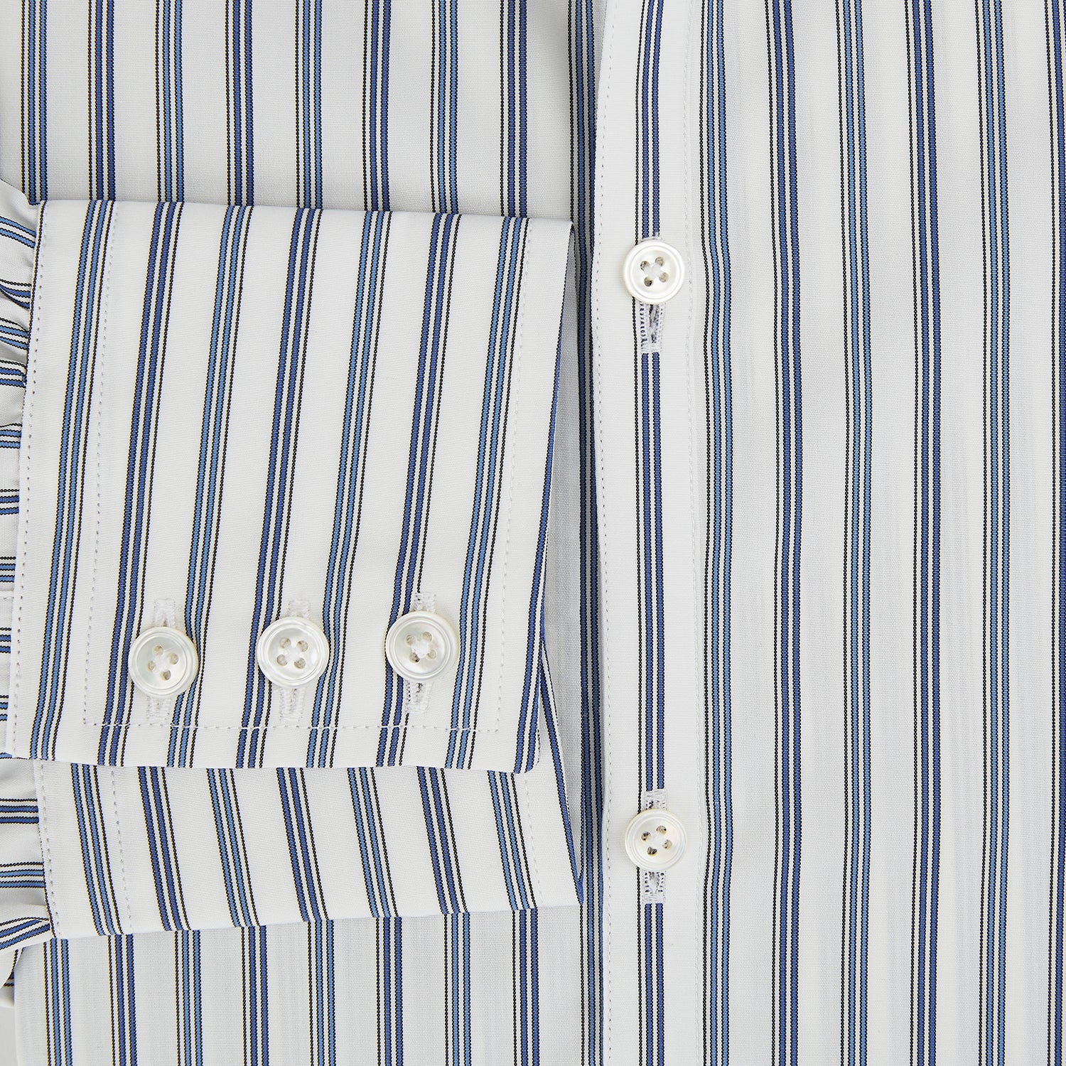 View 4 of product The SAPPHIRE BLUE MULTI TRACK STRIPE WINDSOR SHIRT by Turnbull & Asser features long sleeves, button-up front, classic collar, blue and white vertical stripes, buttoned cuffs, and showcases British craftsmanship on a white background.