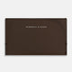 Crafted from dark chocolate leather, the Turnbull & Asser Slim Rounded Card Case features a curved right edge, clean stitching, and the brand’s white embossed logo.