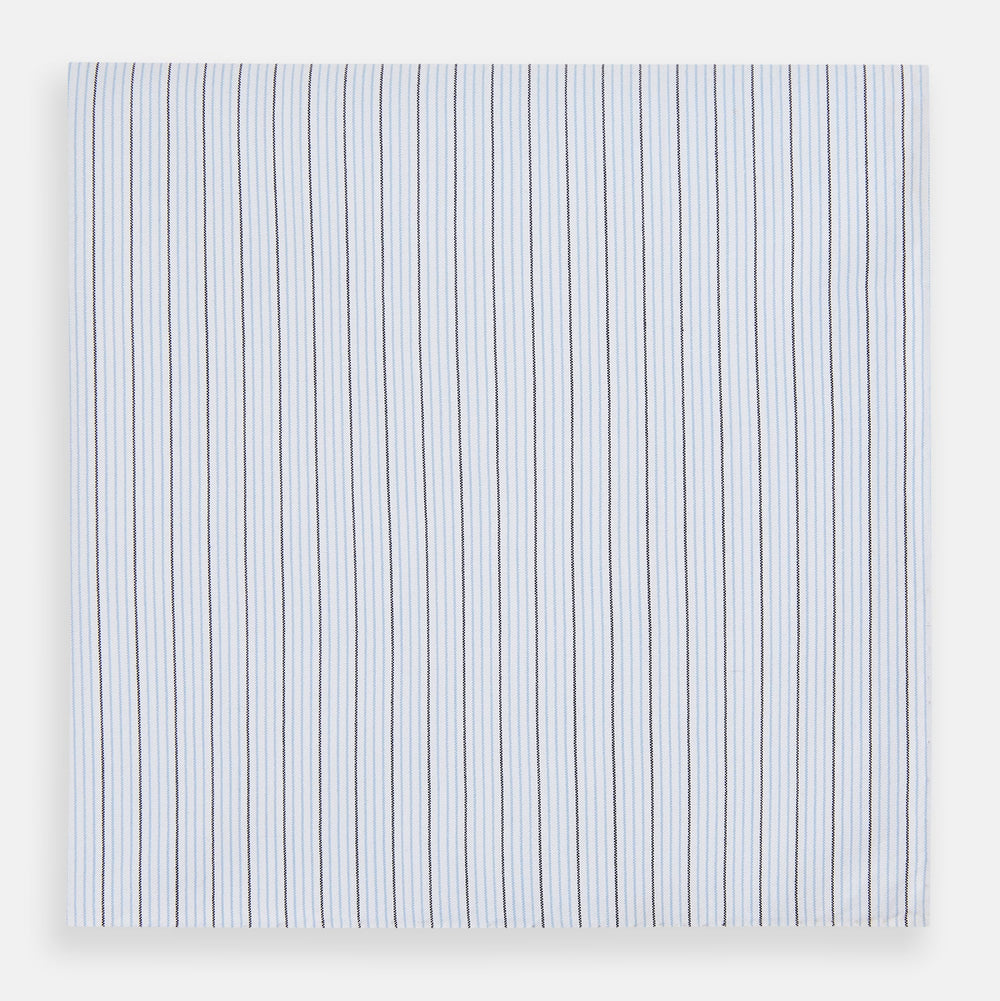The Turnbull & Asser Hand Rolled Blue Multi Stripe Handkerchief features light blue cotton with thin black and white stripes, making it a refined accessory for the gentleman.