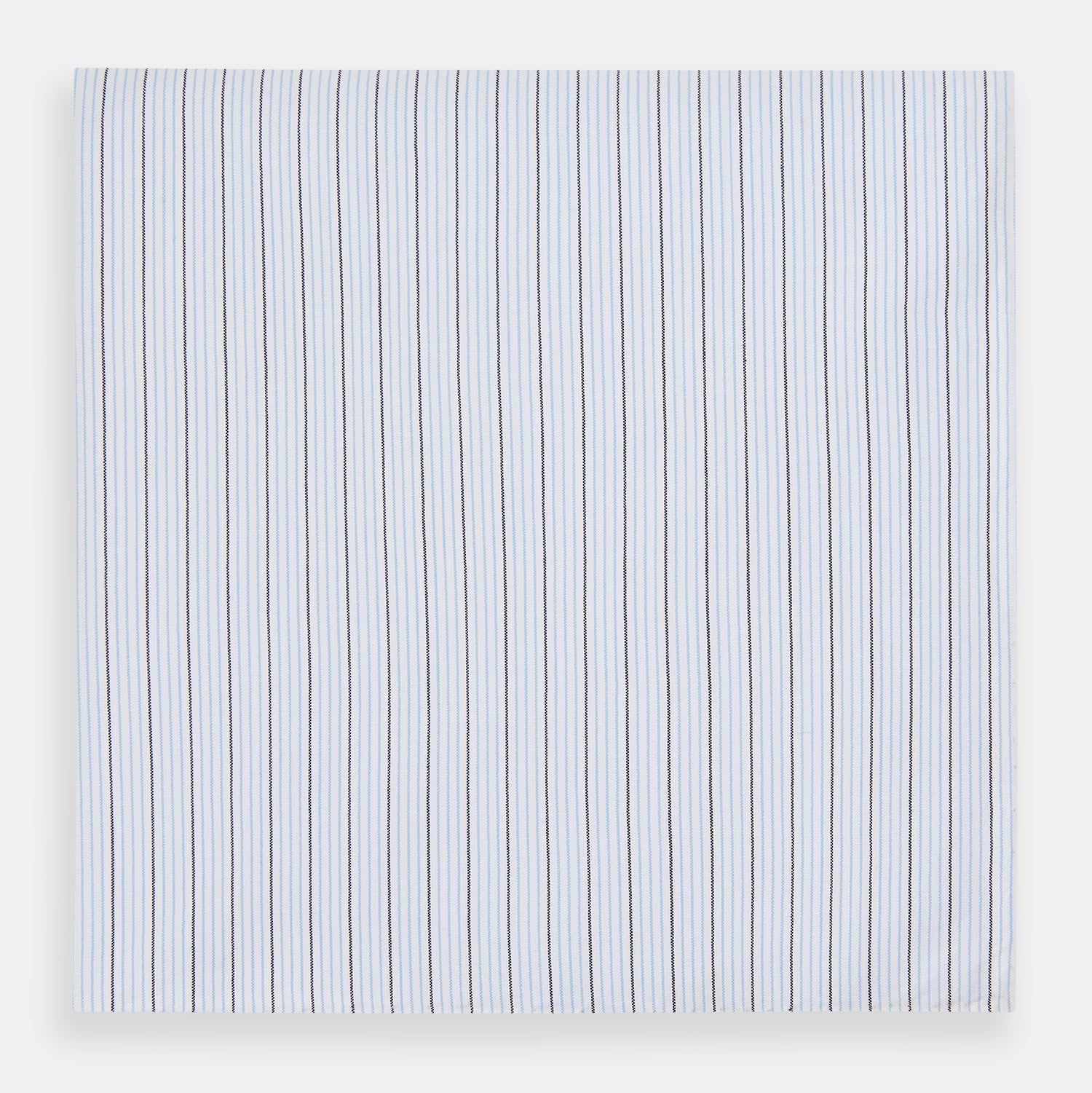 View 1 of product The Turnbull & Asser Hand Rolled Blue Multi Stripe Handkerchief features light blue cotton with thin black and white stripes, making it a refined accessory for the gentleman.