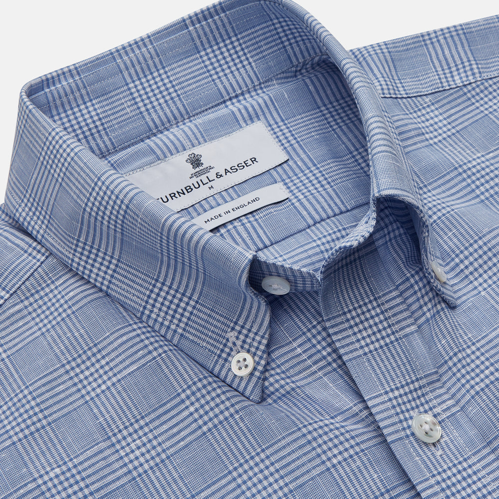 The Turnbull & Asser Pale Blue Multi Check Cotton Weekend Fit Williams Shirt features short sleeves, a pointed collar, single chest pocket, and premium Italian cotton with a subtle checkered pattern, shown on a white background.