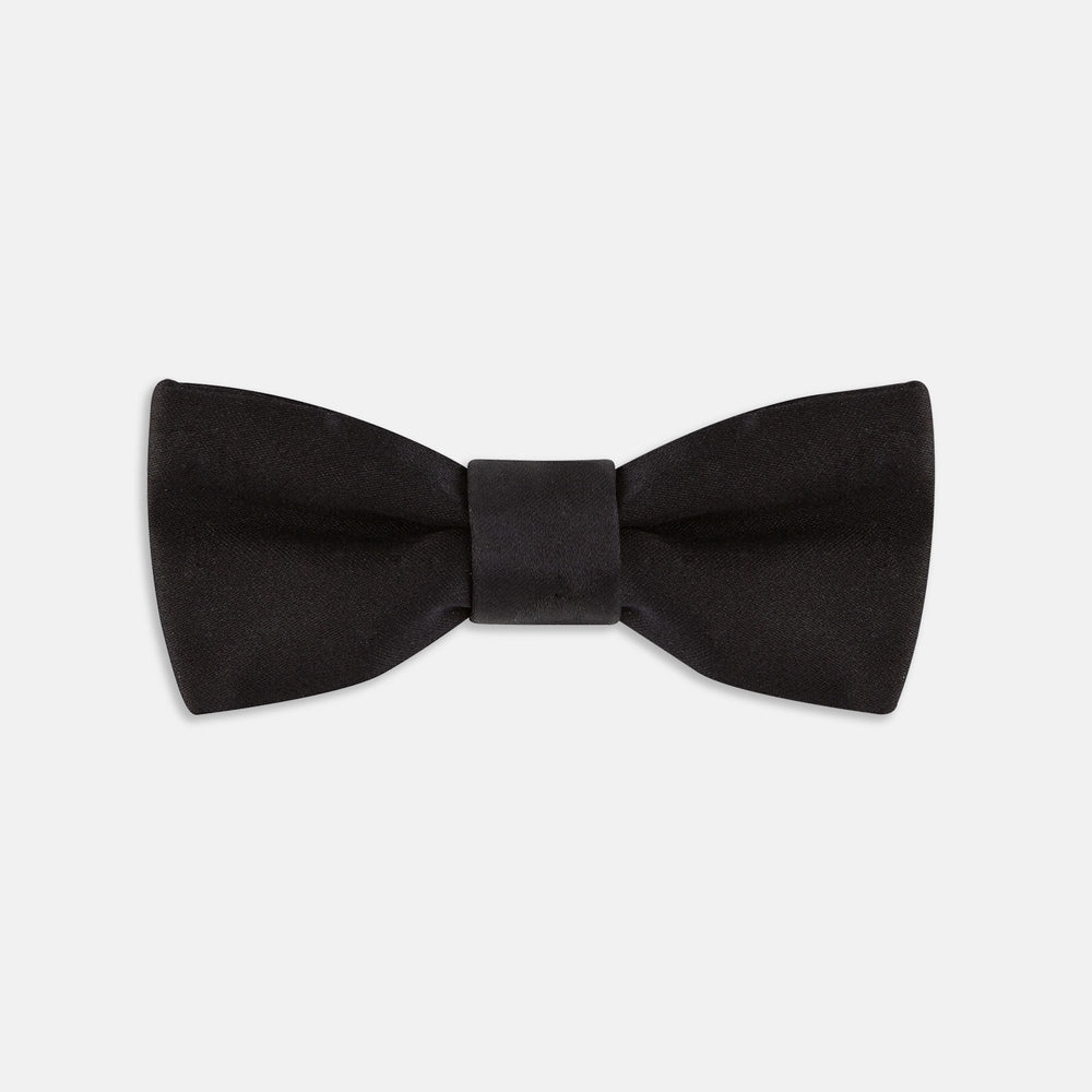 The Turnbull & Asser Black Batwing Satin Bow Tie features a smooth, matte finish and is neatly tied on a plain white background—ideal for formal occasions.