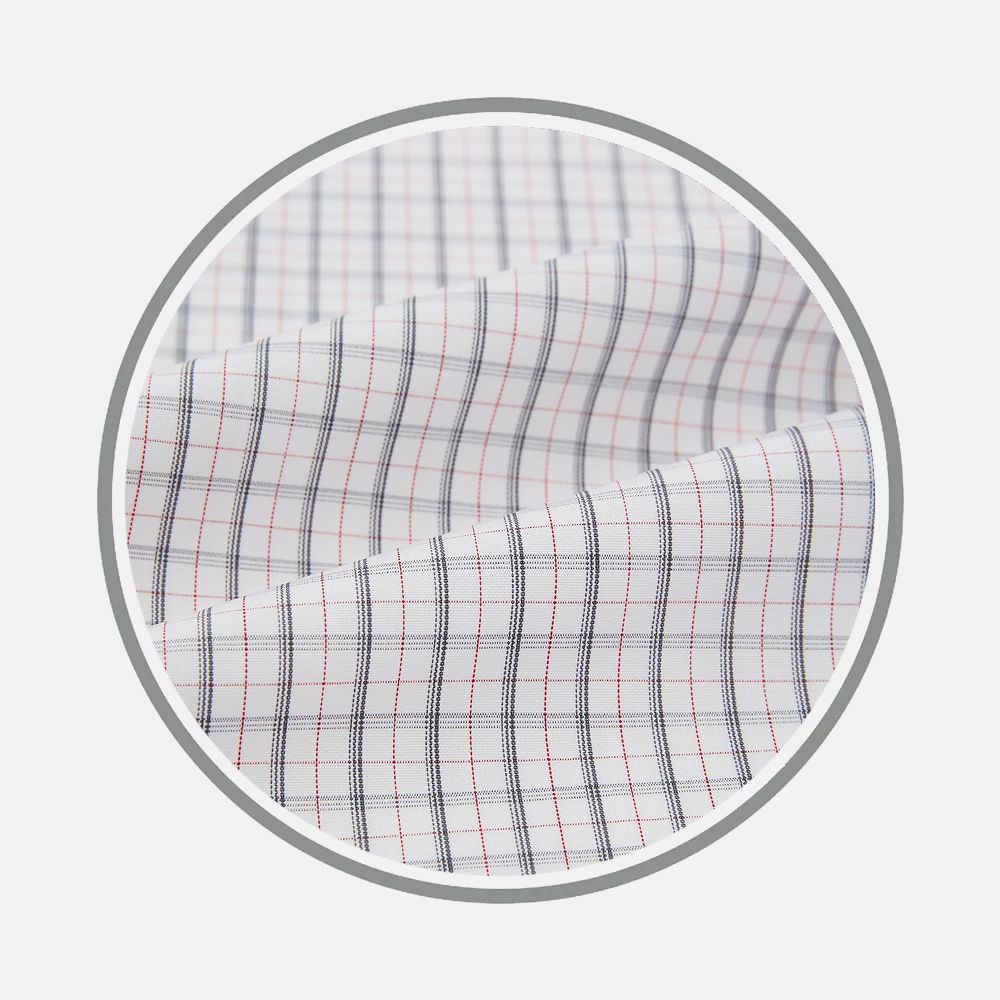 Close-up of Turnbull & Asser’s Blue and Red Graph Check Fabric, featuring a smooth white base with a grid of fine blue and red lines forming small squares, shown within a circular frame against a plain background.