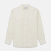 View 1 of product The Turnbull & Asser Cream Cotton Weekend Fit Unwin Shirt features long sleeves, a stand collar, and two chest pockets, shown laid flat on a white background.
