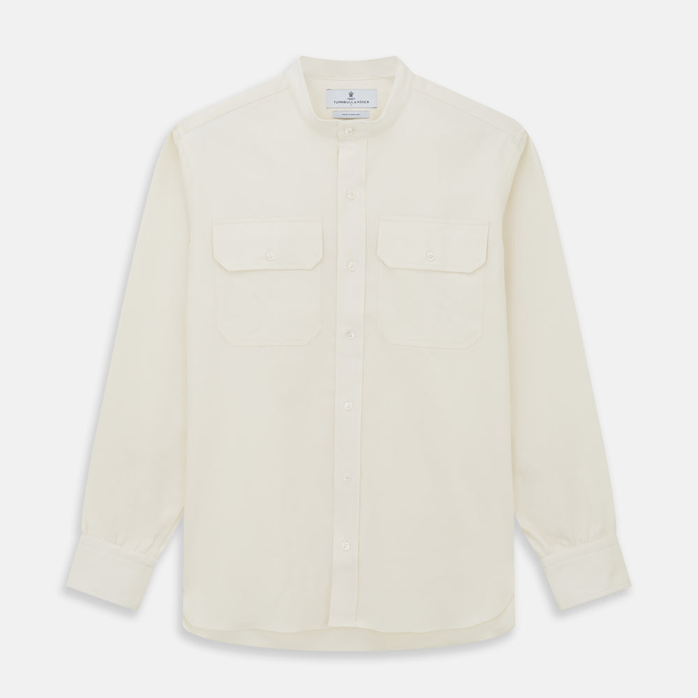 The Turnbull & Asser Cream Cotton Weekend Fit Unwin Shirt features long sleeves, a stand collar, and two chest pockets, shown laid flat on a white background.