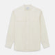 The Turnbull & Asser Cream Cotton Weekend Fit Unwin Shirt features long sleeves, a stand collar, and two chest pockets, shown laid flat on a white background.