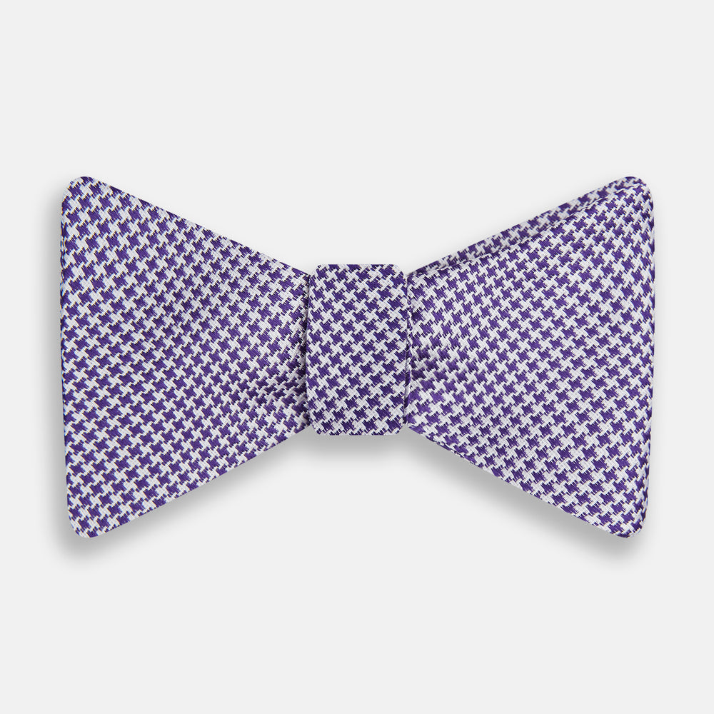The Turnbull & Asser Purple and White Houndstooth Silk Bow Tie, ideal for formalwear, is shown against a white background.