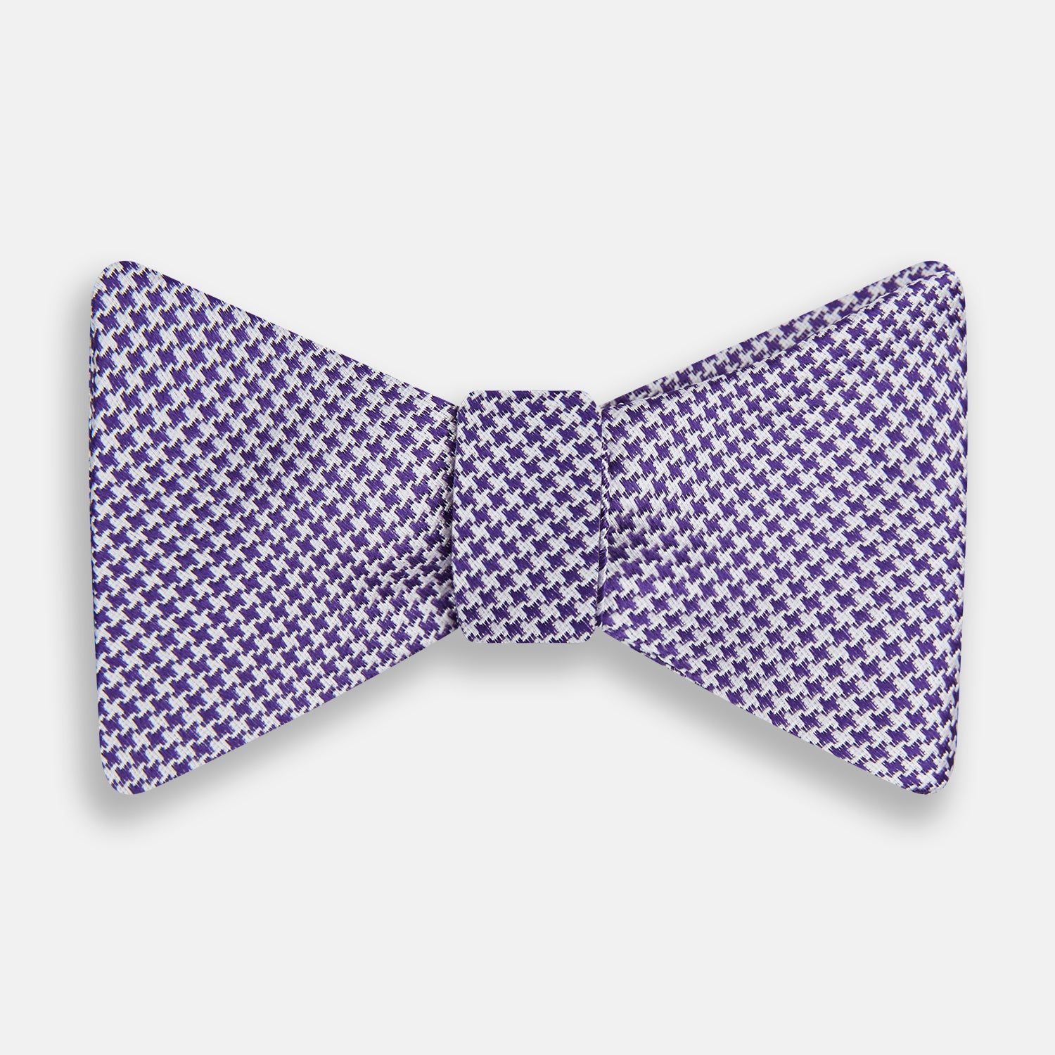 View 1 of product The Turnbull & Asser Purple and White Houndstooth Silk Bow Tie, ideal for formalwear, is shown against a white background.