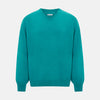 View 1 of product The Turnbull & Asser Turquoise Cashmere V-neck Jumper features long sleeves with ribbed cuffs and hem, displayed on a plain white background—a chic knitwear addition.