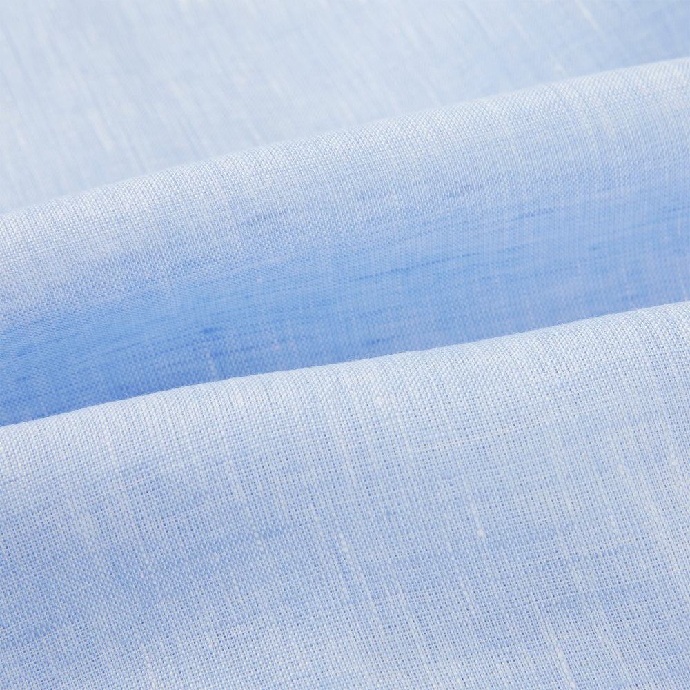 The Turnbull & Asser Pale Blue Linen Pyjama Shirt features long sleeves, a collar, front buttons, and a chest pocket—perfect as elegant loungewear or nightwear.