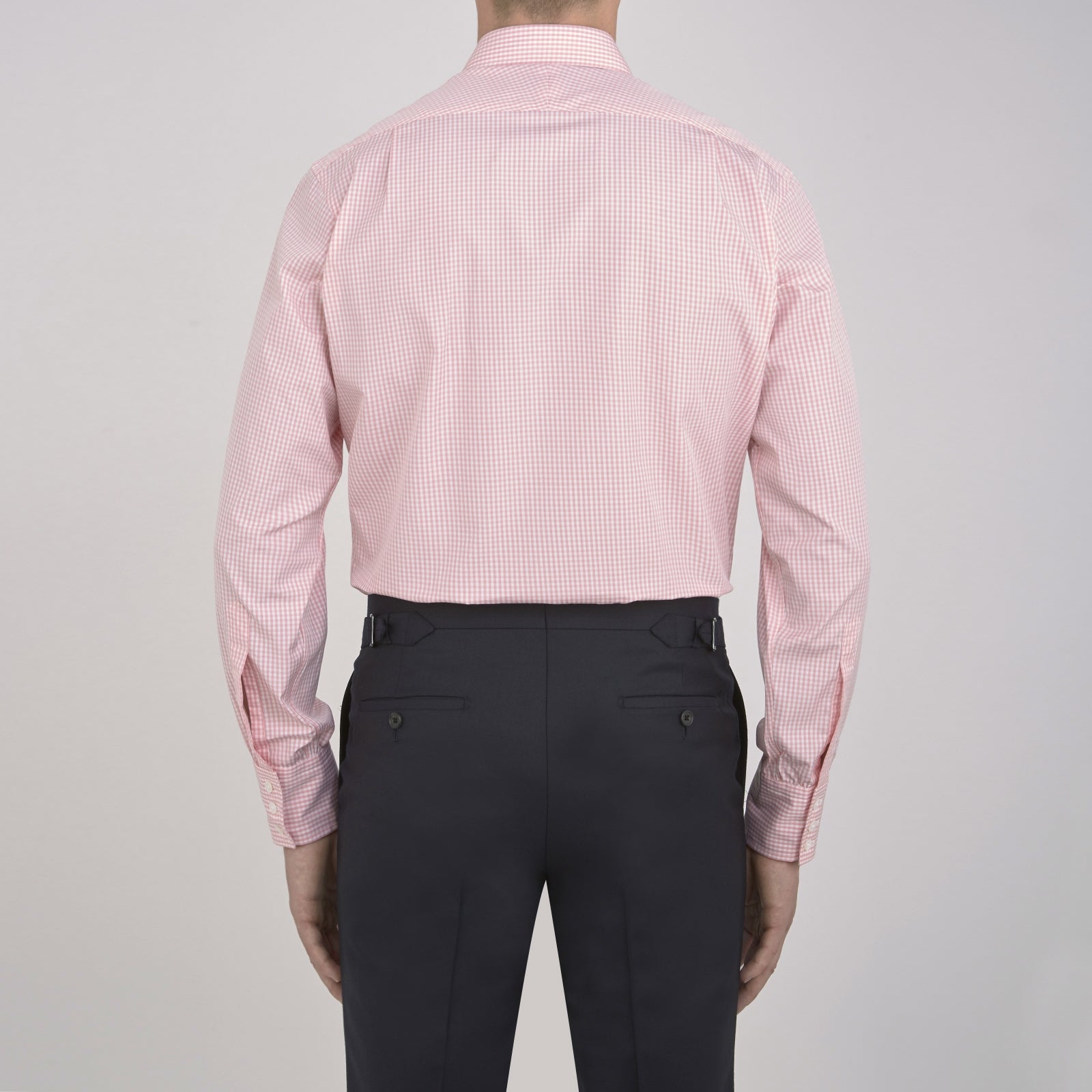 View 3 of product The Turnbull & Asser Light Pink Gingham Check Shirt features a classic T&A collar, 3-button cuffs, and white buttons, neatly folded on a plain white background.