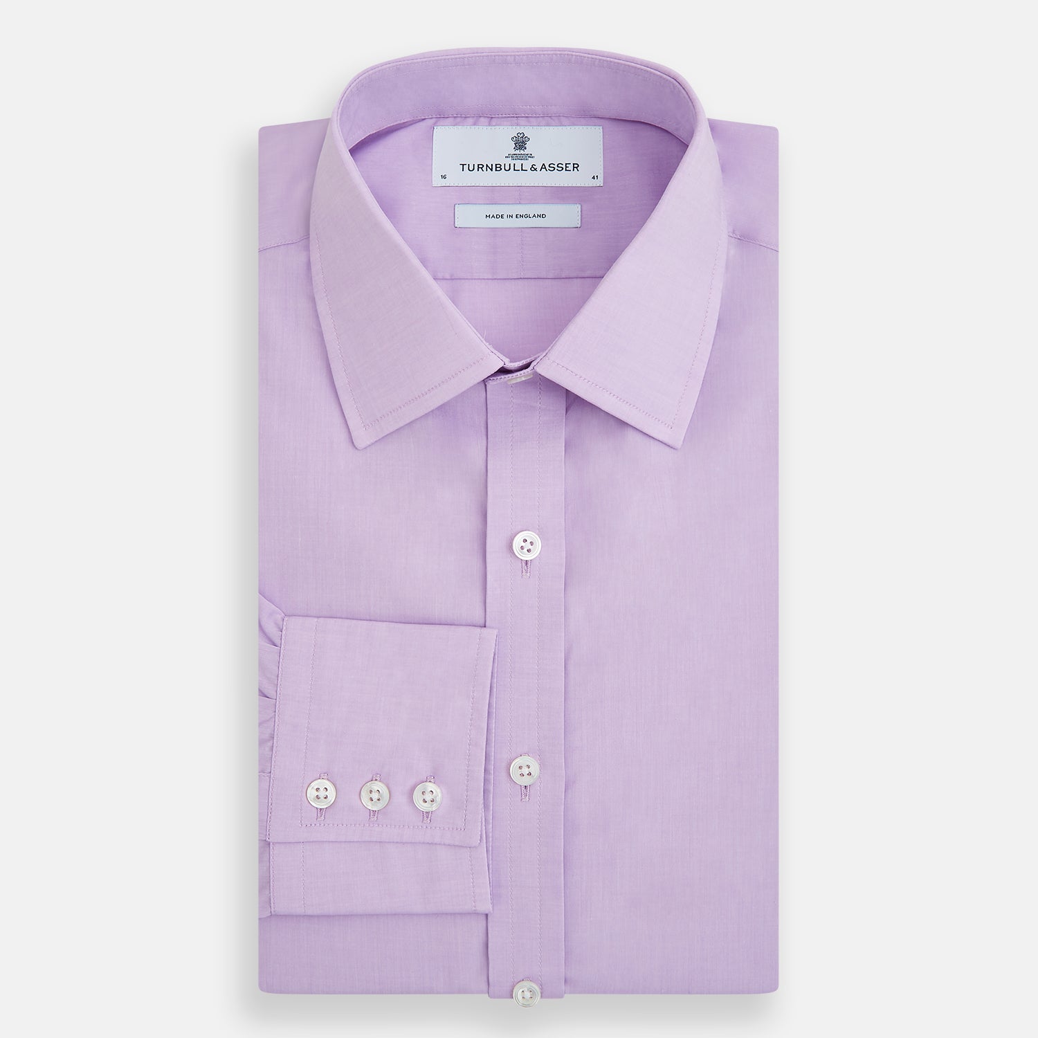View 5 of product The Turnbull & Asser Purple Pink Mayfair Shirt is a men's formal, long-sleeve button-up with a classic collar and buttoned cuffs, shown in light purple against a plain white background.