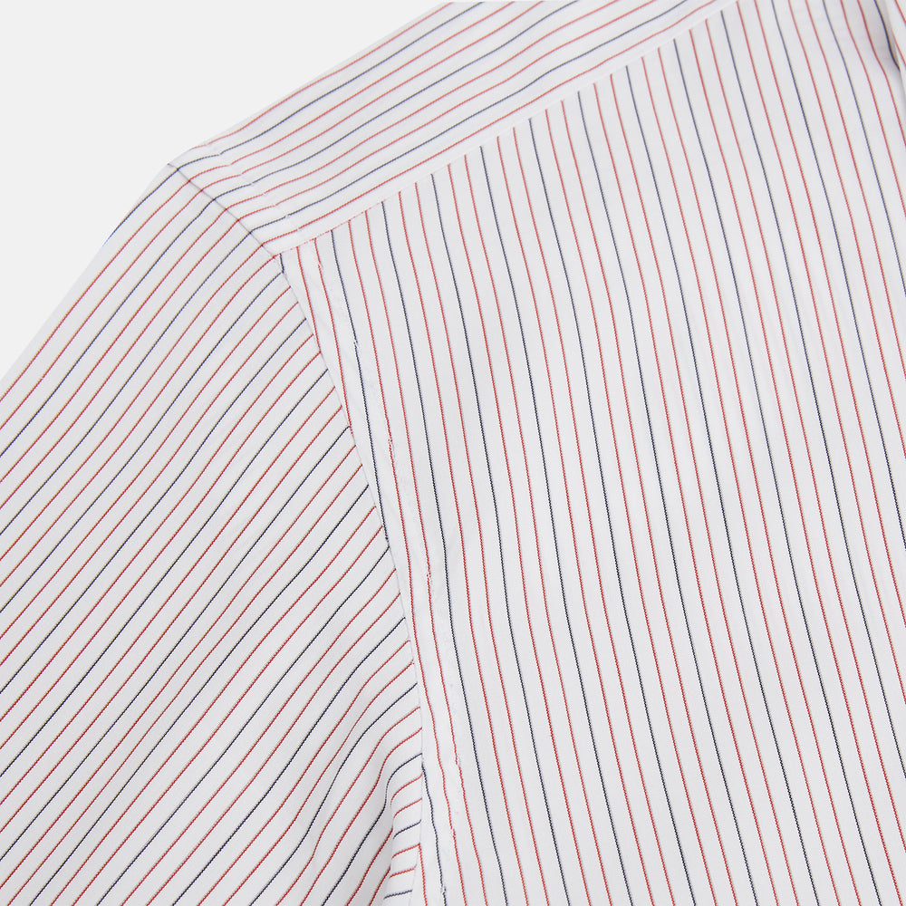 The Turnbull & Asser Red and Blue Ticking Stripe Westminster Shirt features long sleeves, a button-up front, pointed collar, and buttoned cuffs, highlighting British craftsmanship while laid flat on a white background.