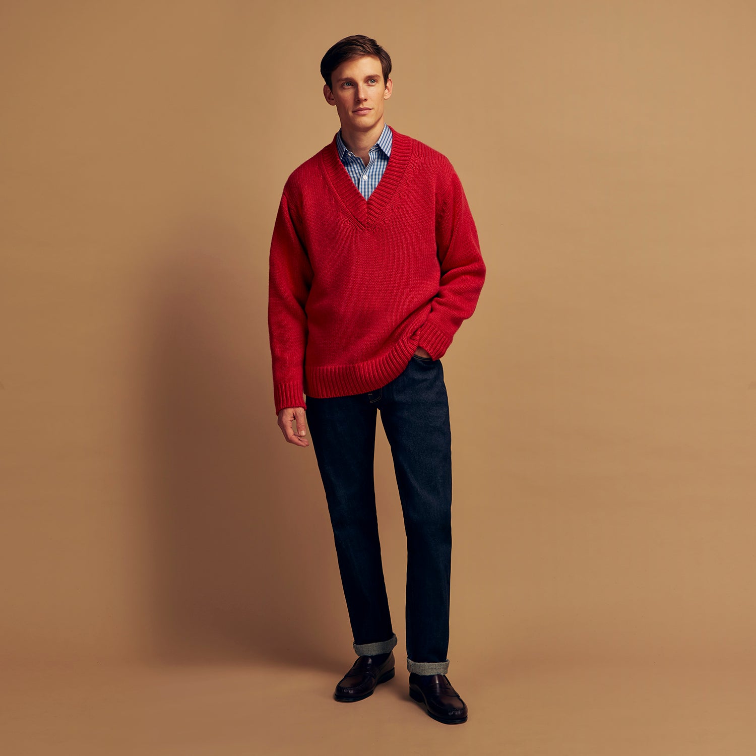 View 2 of product The Turnbull & Asser Raspberry Red Cashmere Edwards V-Neck Sweater features long sleeves, ribbed cuffs and hem, and is shown laid flat on a white background.
