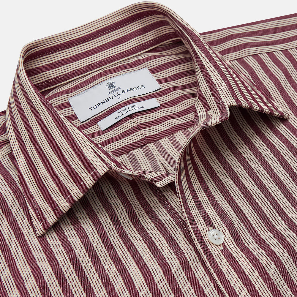 The Turnbull & Asser Burgundy Multi Stripe Weekend Fit Wool Shirt features a Derby collar, 1 button cuffs, and vertical red and white stripes, ideal for casual wear, shown against a white background.