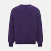 View 8 of product The Turnbull & Asser Purple Cashmere Round Neck Jumper features long sleeves, ribbed cuffs, hem, and collar for an elegant silhouette. This versatile knitwear piece is shown against a white background.