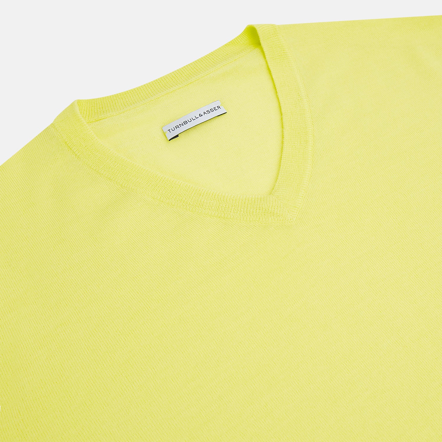 View 2 of product The Turnbull & Asser Bright Yellow Cashmere V-neck Jumper, a plain long-sleeved knitwear sweater, is showcased against a white background.