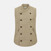 View 1 of product The Turnbull & Asser Sand Double-Breasted Quilted Gilet features a sleeveless design, brown buttons, slanted chest pocket, and two zippered side pockets—perfect for modern layered dressing. Shown on a plain white background.