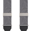 View 2 of product The Turnbull & Asser Silver Paisley Adjustable Silk Braces feature gray paisley silk with silver fittings and black leather ends, offering refined style. The symmetrical braces are displayed flat on a white background.