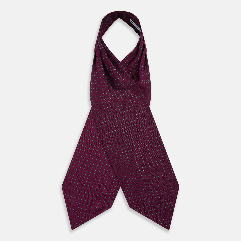 A burgundy pocket square with turquoise polka dots, folded to a point—an ideal men's formal accessory to complement the Green Micro Dot and Magenta Silk Cravat by Turnbull & Asser.