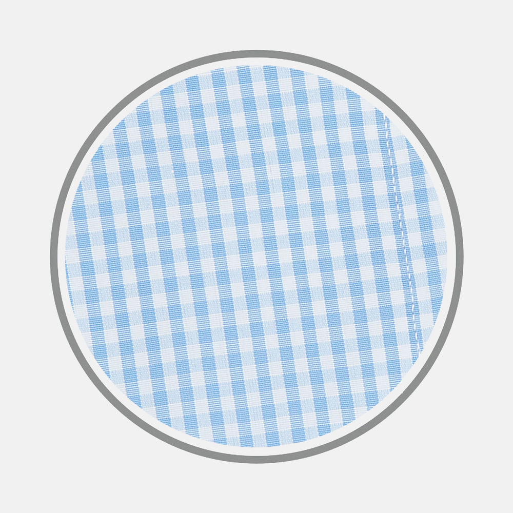 A circular swatch of Turnbull & Asser's Light Blue Gingham Check Cotton Fabric, featuring a simple light blue and white checkered pattern, is bordered by a thin gray outline on a white background.