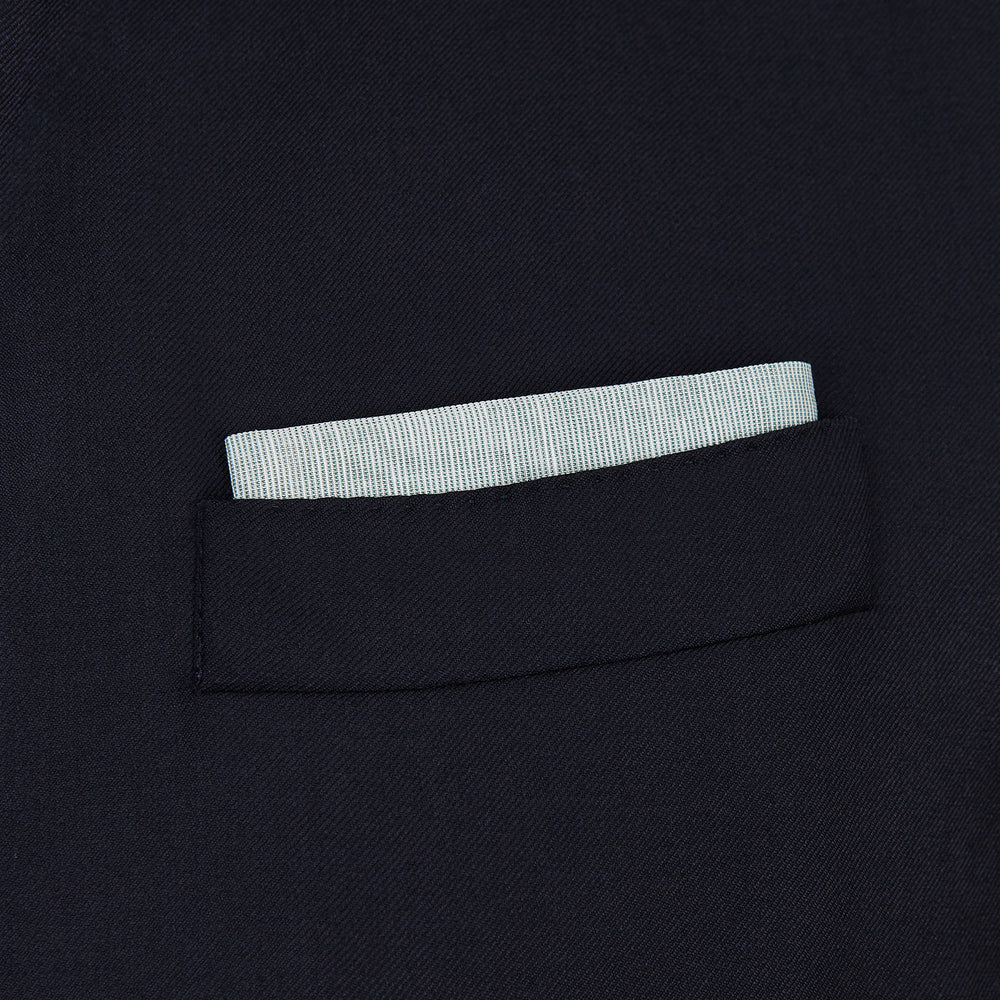 A neatly folded green cotton-blend Turnbull & Asser handkerchief with visible hand-rolled edges and one corner flipped over, showing the reverse side.