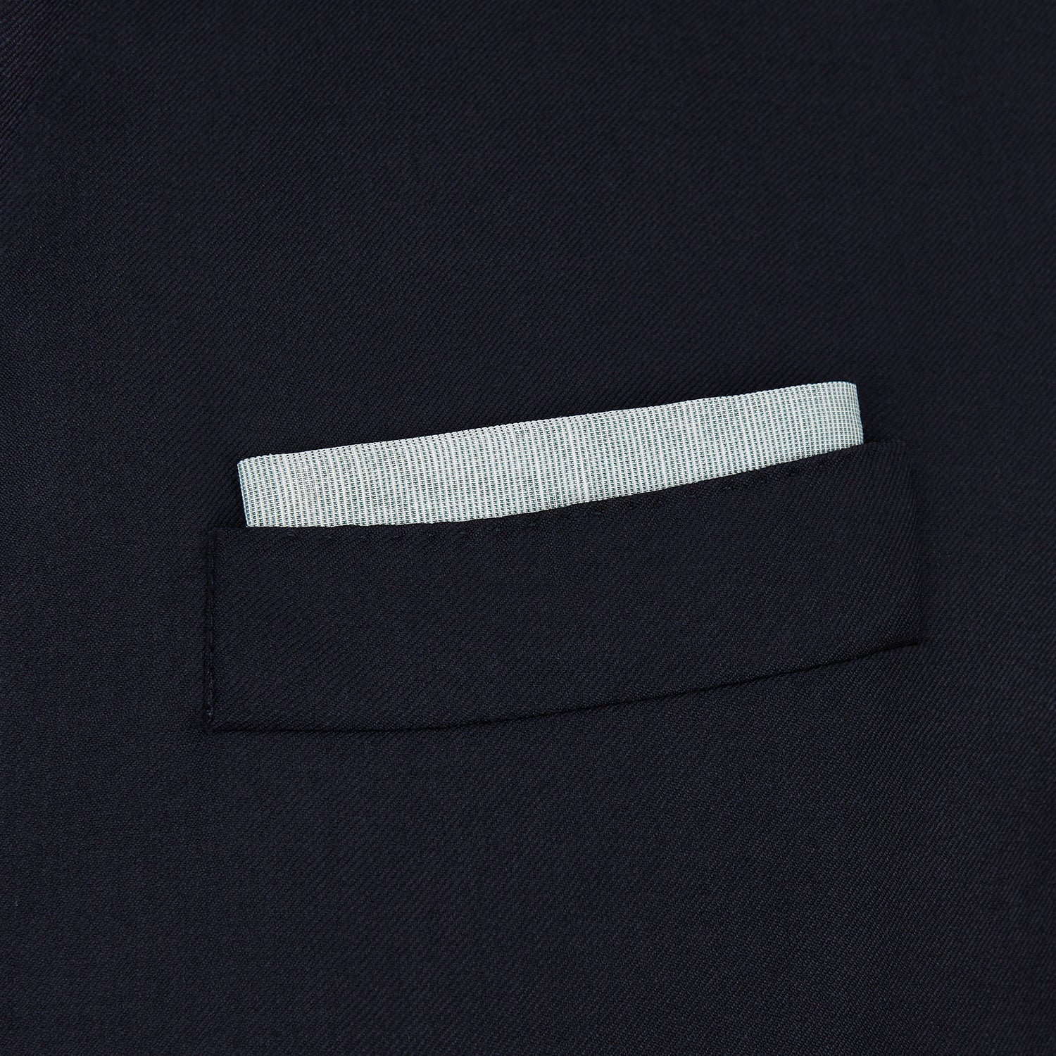 View 2 of product A neatly folded green cotton-blend Turnbull & Asser handkerchief with visible hand-rolled edges and one corner flipped over, showing the reverse side.
