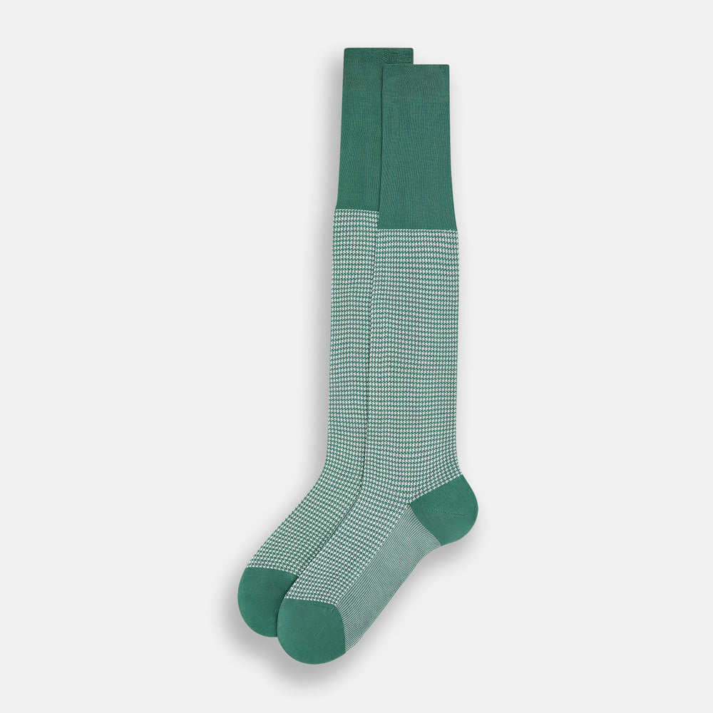 The Ivory/green Houndstooth Long Sock by Turnbull & Asser features a houndstooth pattern on the lower half with a solid green upper band, heel, and toe, shown against a white background.