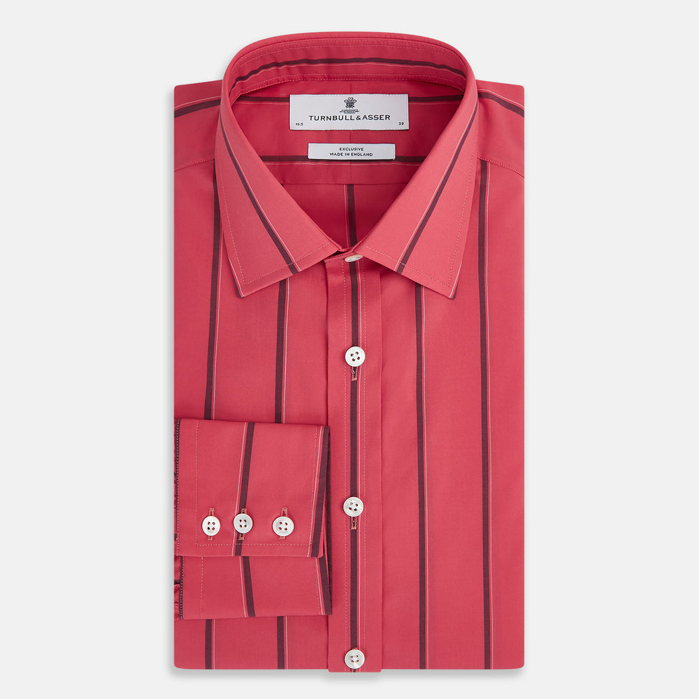 The Coral Red Track Stripe Mayfair Shirt by Turnbull & Asser features long sleeves, button-up front, a classic T&A collar, and buttoned cuffs in vibrant Italian cotton with vertical black pinstripes, shown on a plain white background.