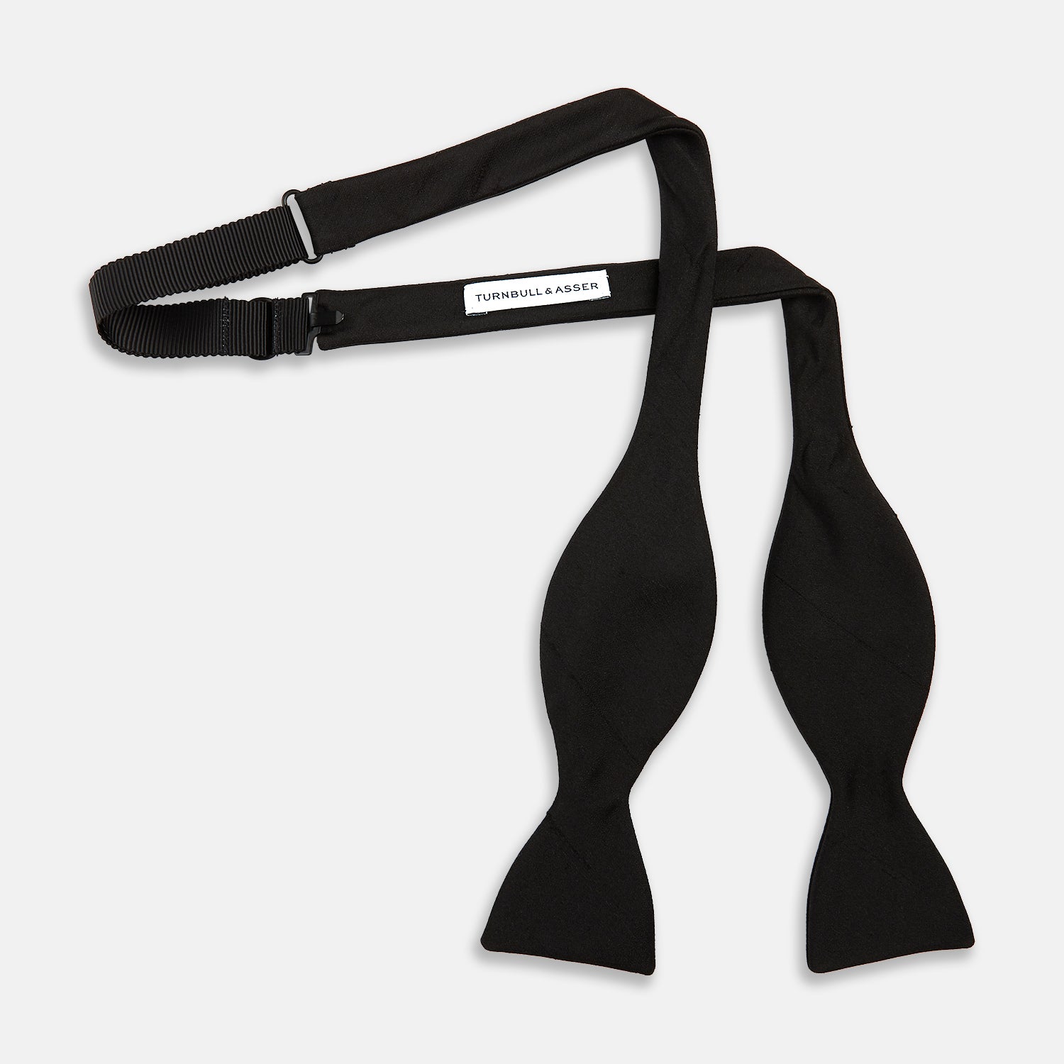 View 2 of product The Casino Royale Shantung Silk Bow Tie by Turnbull & Asser, as seen on James Bond, features a classic shape in black silk and is set against a plain white background—a timeless gentleman’s accessory.