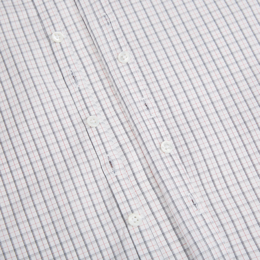 The Blue and Red Graph Check Westminster Shirt by Turnbull & Asser features a classic collar, long sleeves, and British craftsmanship, with a blue and red checkered pattern on white, displayed flat on a white surface.