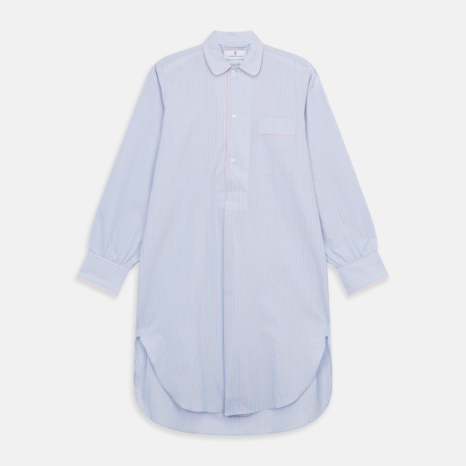 View 1 of product The Blue and Pink Stripe Poplin Cotton Nightshirt by Turnbull & Asser features long sleeves, a collar, front buttons, chest pocket, rounded hem, and light blue fabric with white, pink, and yellow vertical stripes.