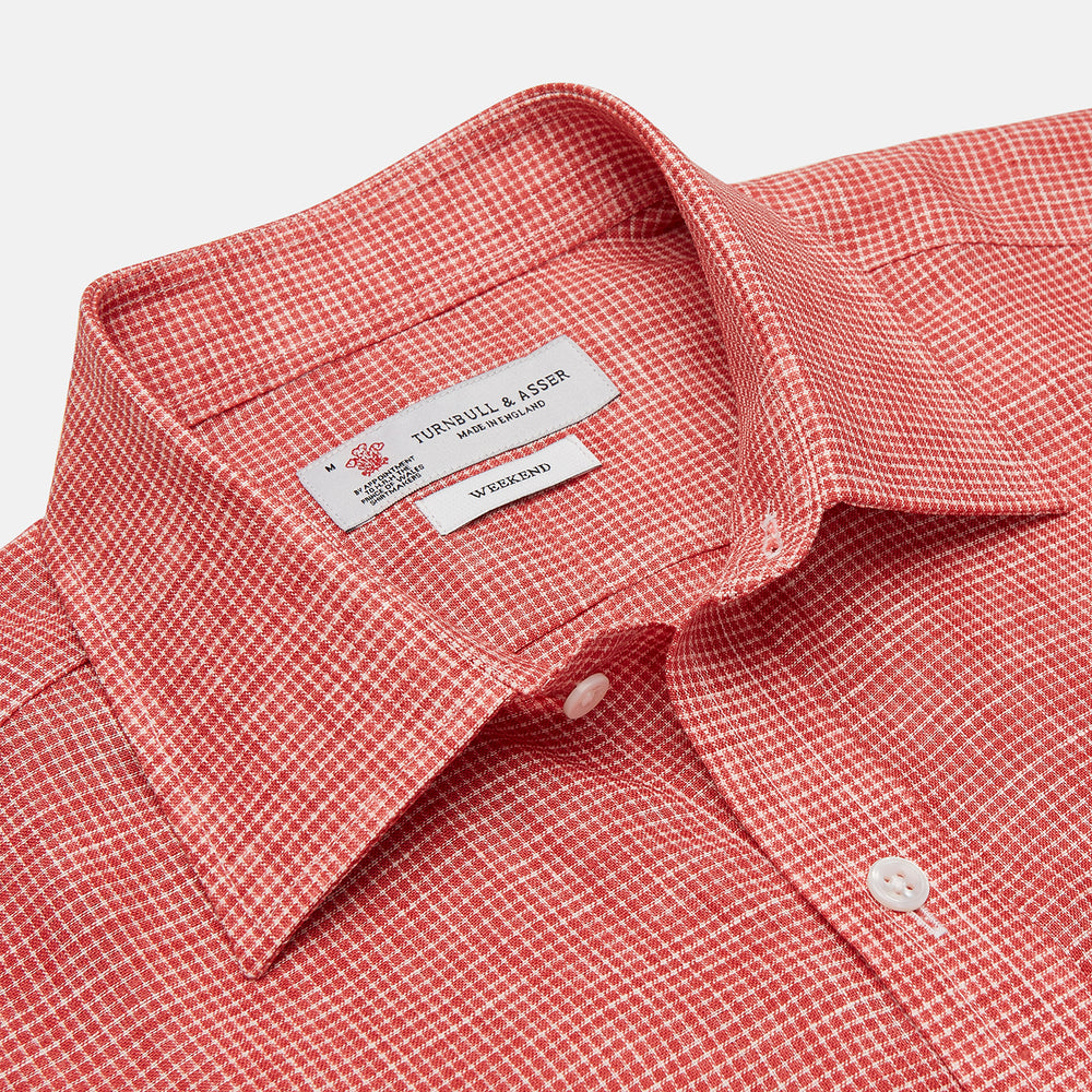 The Turnbull & Asser Weekend Fit Red Check Linen Shirt features a Derby collar, long sleeves with 1-button cuffs, and a single chest pocket—ideal for summer style. Shown against a plain white background.