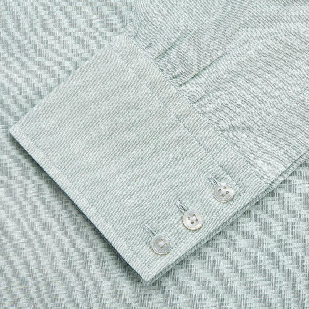 The Turnbull & Asser Light Green Chambray Regular Fit Mayfair Shirt for men features long sleeves, a collar, white buttons, and buttoned cuffs, displayed flat on a white background.