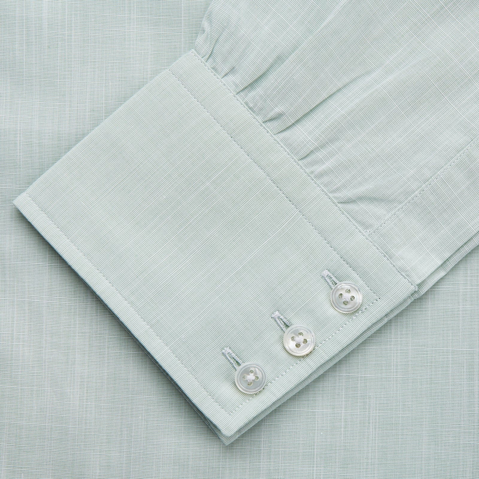 View 3 of product The Turnbull & Asser Light Green Chambray Regular Fit Mayfair Shirt for men features long sleeves, a collar, white buttons, and buttoned cuffs, displayed flat on a white background.