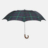 View 1 of product The Turnbull & Asser Colquhoun Tartan Telescopic Umbrella features a green, blue, and red plaid canopy, a durable metal shaft, and a brown maple crook handle, displayed against a plain light background.