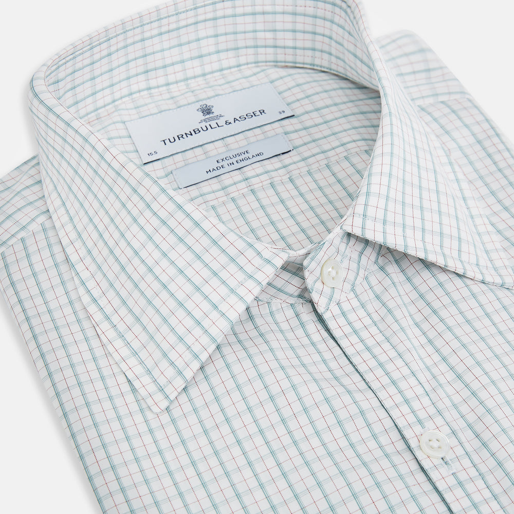 The Turnbull & Asser Turquoise and Red Multi Check Westminster shirt features long sleeves, a standard collar, and buttoned cuffs, showcasing fine British craftsmanship. It’s pictured laid flat on a white background.