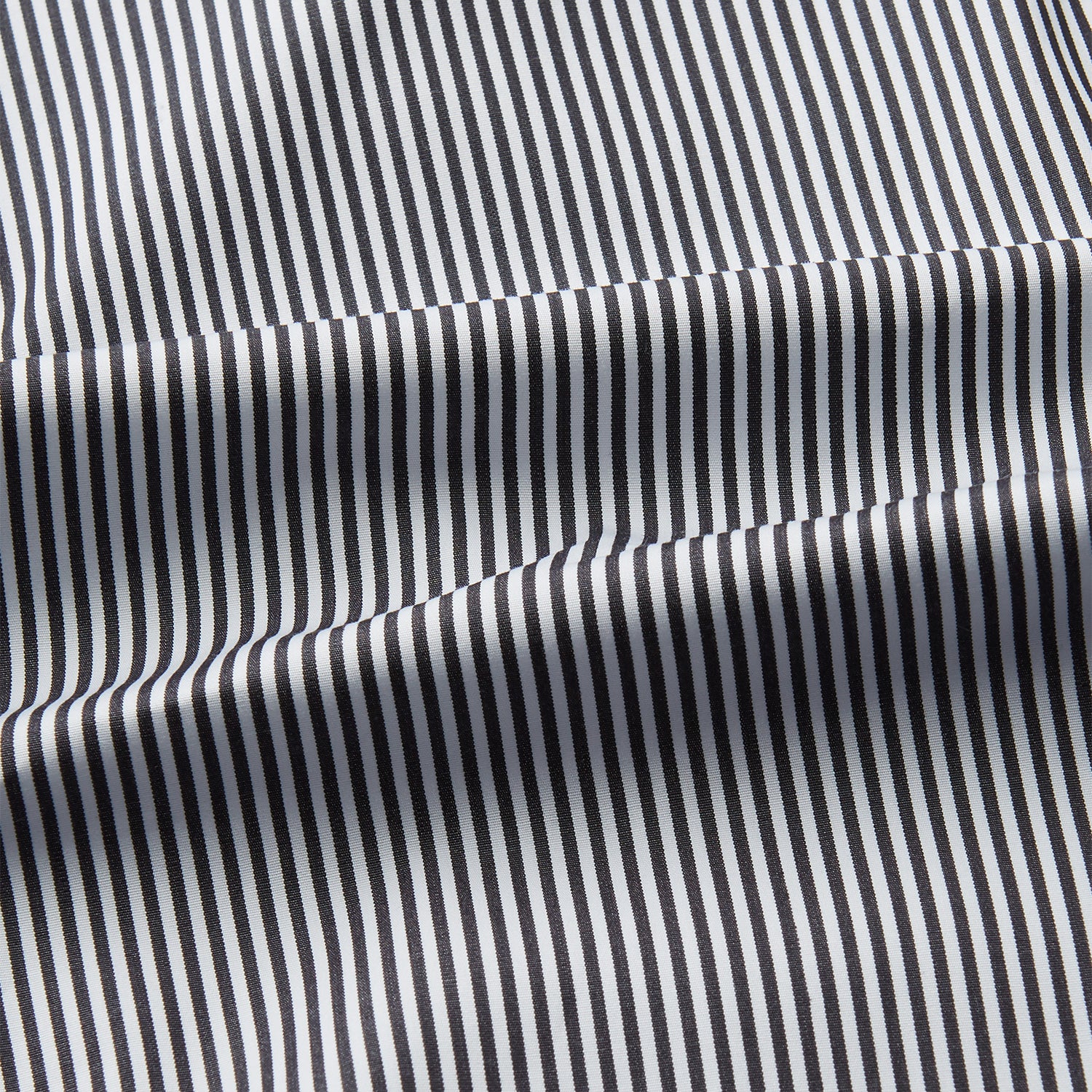 View 4 of product The Turnbull & Asser Black Candy Stripe Cotton Regular Fit Mayfair Shirt features long sleeves, a T&A collar, white buttons, and thin black stripes, displayed on a plain white background.