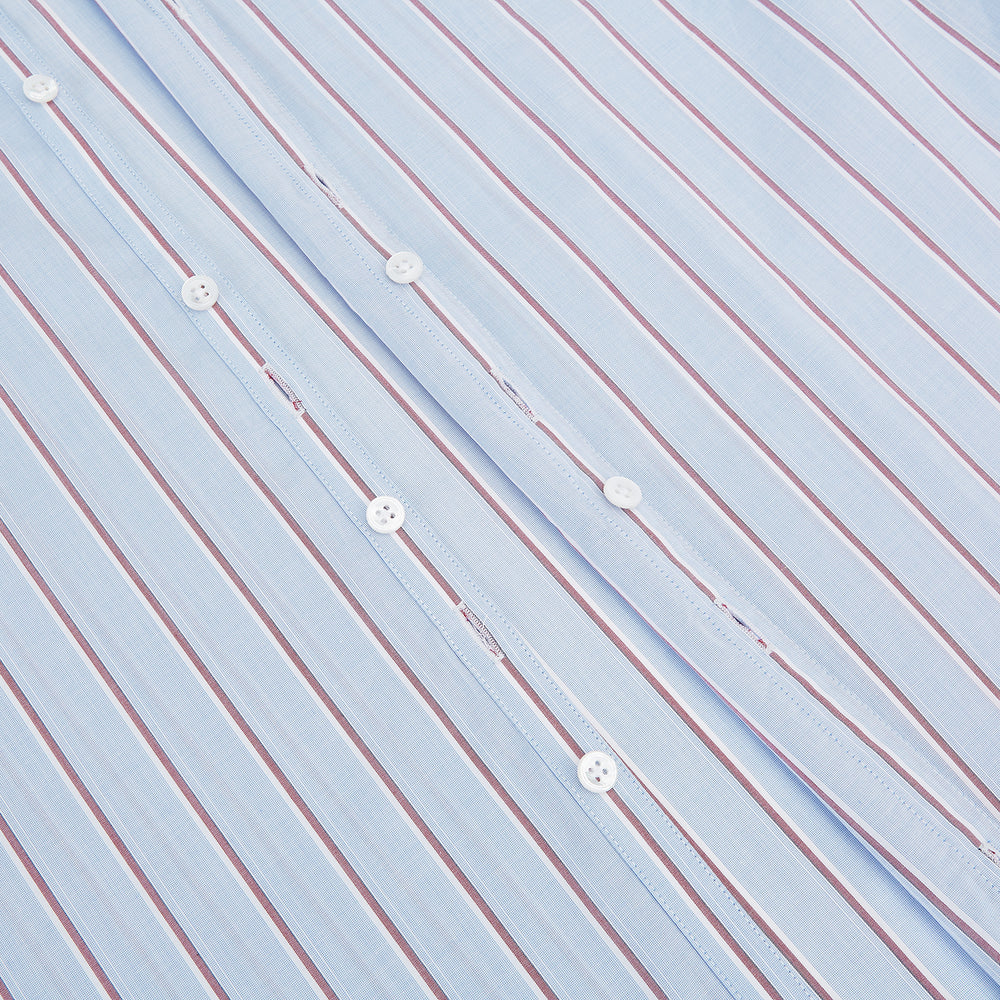 The Turnbull & Asser Blue and Burgundy Multi-Stripe Westminster Shirt features a pointed collar and long sleeves, laid flat on a white background to highlight its fine British craftsmanship.