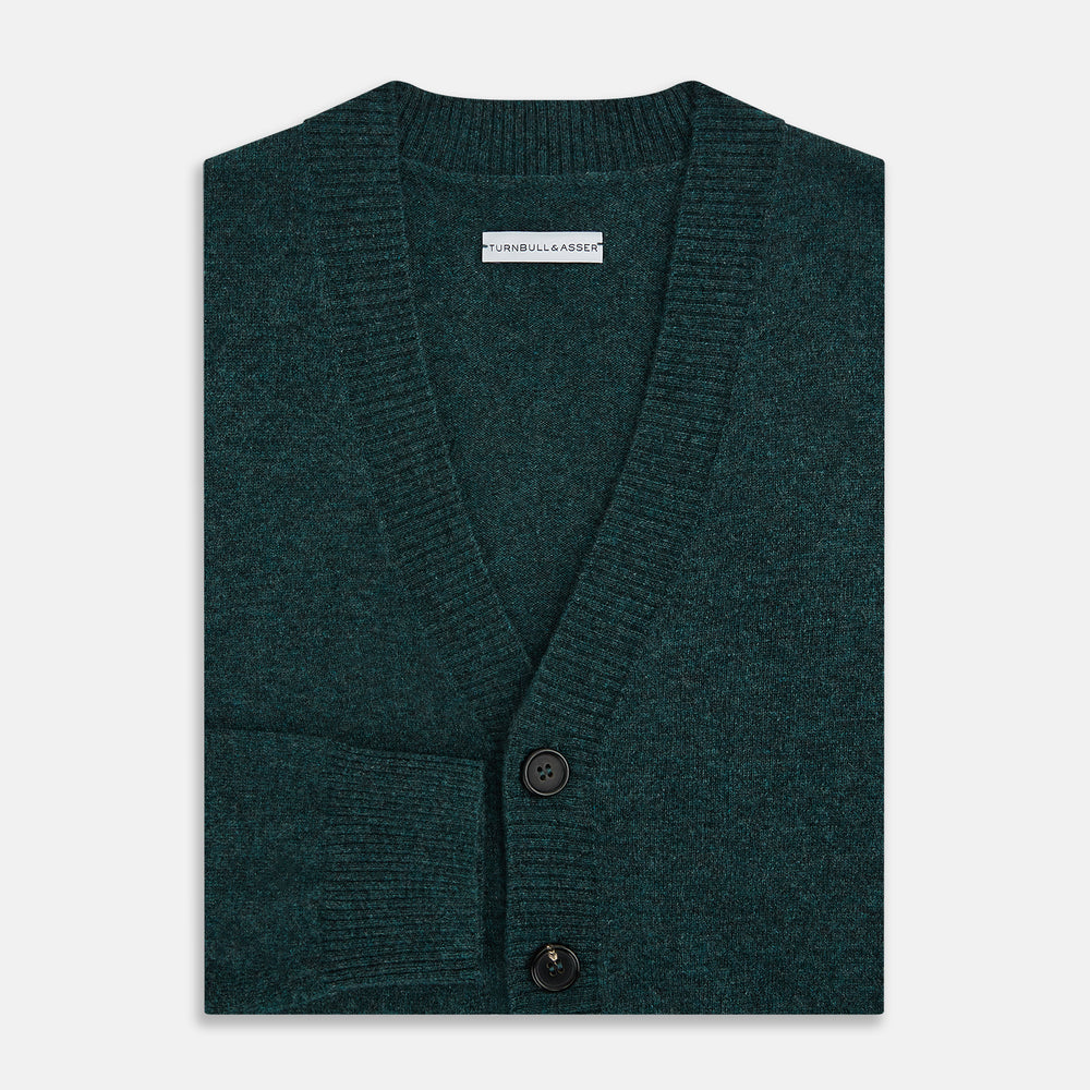 Turnbull & Asser’s Green Melange Cashmere Cardigan features a V-neck, long sleeves, ribbed cuffs and hem, two front pockets, and a button-up front—an essential knitwear piece shown against a white background.