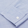 View 3 of product The Turnbull & Asser Mid-Blue Chambray Weekend Fit Shirt features a Dorset collar, white buttons, and 1-button cuffs. It is laid flat on a white background.